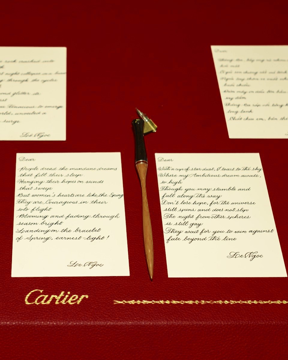 Handwritten poem cards on a Cartier leather table